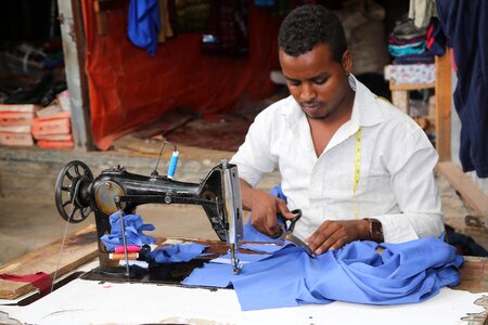 Man tailor sewing machine photo