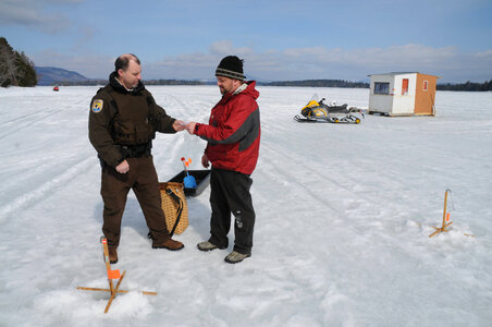 Law enforcement spot checks an ice fisherman photo