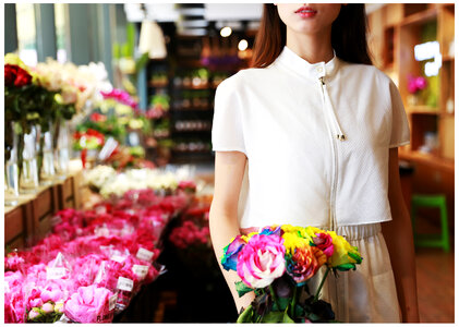 Woman in Florist Holding Colorful Roses photo