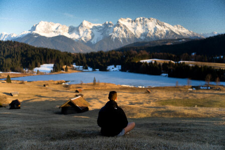 Man looking at Snow-capped Mountains landscape in Bavaria, Germany photo