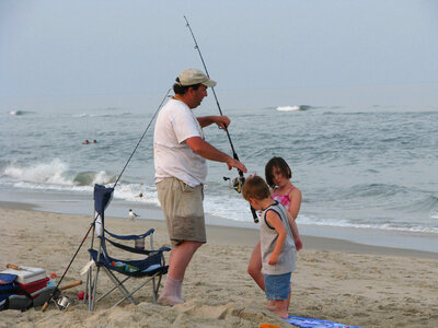 Dad and his children surf fishing photo
