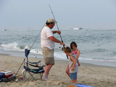 Dad and his children surf fishing