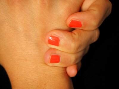 Fingernails lacquered red