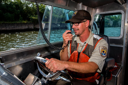 Fishery biologist pilots boat while collecting data on Asian carp-3