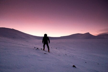 Purple Sunset in the winter of person hiking in the snow in Quebec, Canada photo