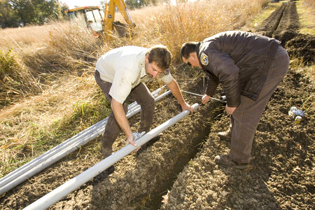 U.S. Fish and Wildlife Service employees laying pipe