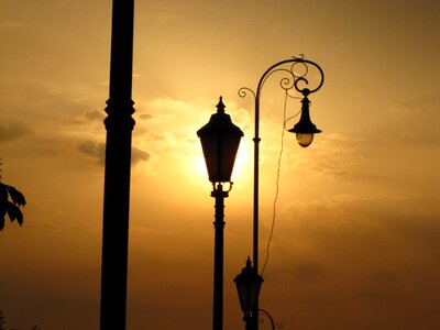 Sunlight clouds street lamp photo