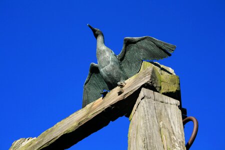 Wood statue seaside photo