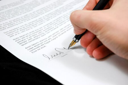 Man signing business document, application, subscription photo