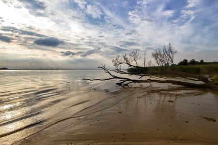 Shoreline with clouds in the sky during late afternoon photo