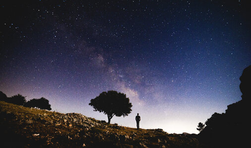 Man Watching the Amazing Starry Sky at Night photo