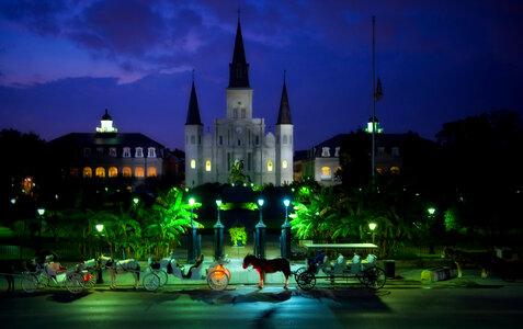 New Orleans evening city with horse carriages in Louisiana