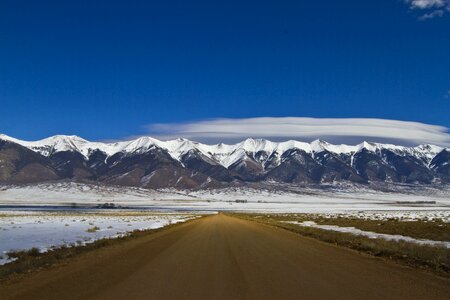 Asphalt blue dirt road photo