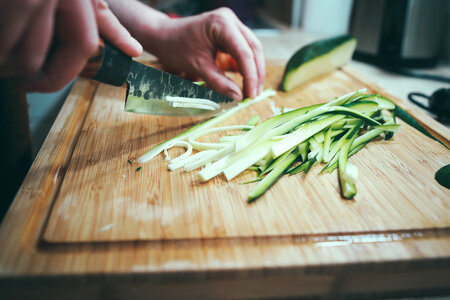 Cut Zucchini in Long Strips on Chopping Board for Cooking photo