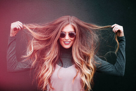 Smiling Woman in Sunglasses with Long Hair photo