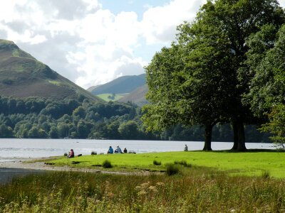People relaxing by the lake