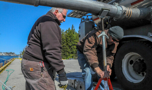 FWS staff loading juvenile lake trout onto MV Spencer Baird-2 photo