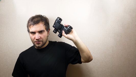 young man with binoculars photo