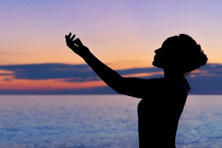 Woman with Arms Outstretched towards the Sky