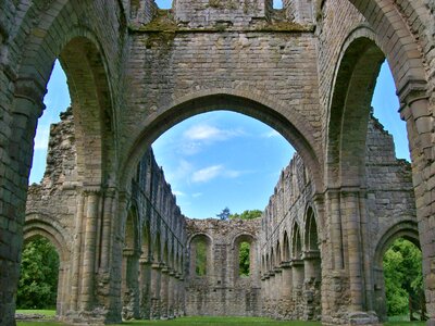 Indoor view of old roofless abandoned cathedral in San Galgano