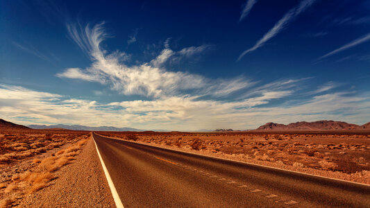 Roadway in the desert under the clouds photo