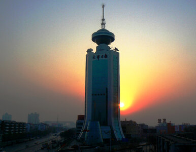 Tower in front of the setting sun in Tianjin, China photo