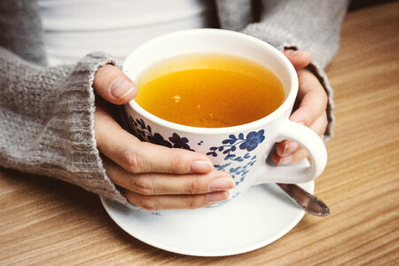 1 Female hands holding hot cup of tea photo