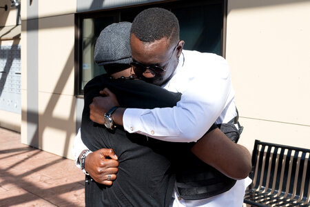 Black men hugging photo