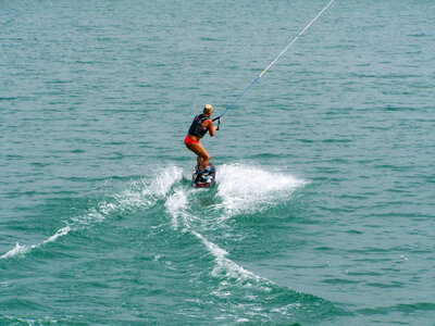 Woman waterboarding on lake photo