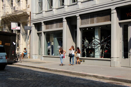 Beautiful young woman wearing dress and walking on the street photo