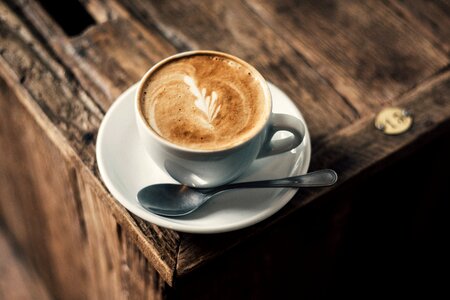 Cappuccino Coffee on Rustic Wooden Table photo