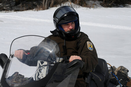 Service law enforcement by snowmobile photo