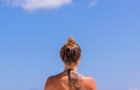 Tanned Woman's Back against the Blue Sky photo