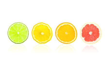 Citrus slices fruits isolated on white. Pieces fresh of orange, lime, lemon, grapefruit in row. photo
