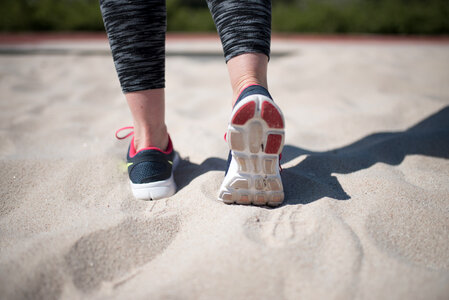 Sporty Woman Walking On Sand photo