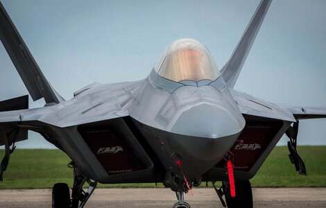 An F-22A Raptor sits parked on the flightline