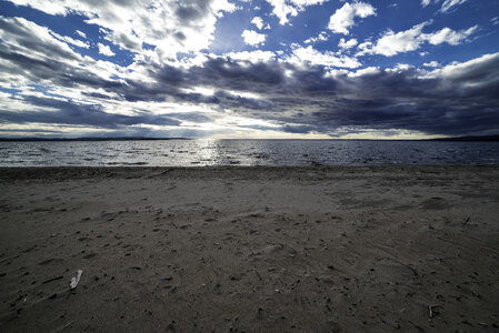 Beach and Shoreline with clouds and sky with sun photo