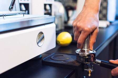 Pressing coffee in portafilter photo