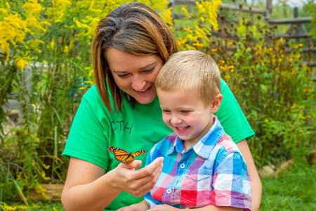 Woman and child with monarch butterfly