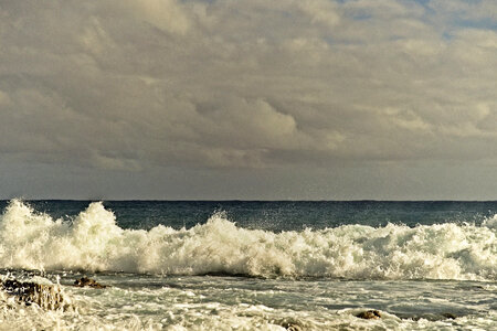 Large waves and surf coming in from the ocean photo