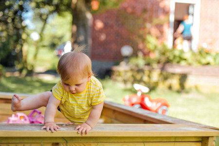 The Little Kid Is Trying to Get out of the Sandbox photo