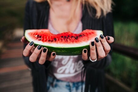 Girl eating watermelon outside photo
