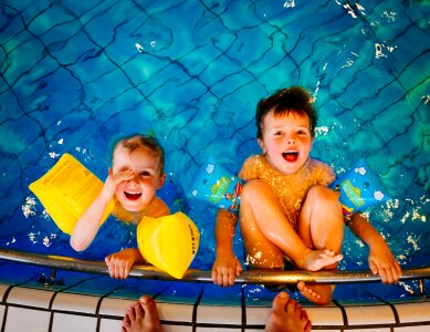 happy children kids group at swimming pool class learning to swim photo