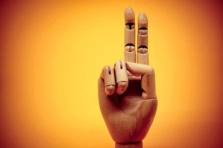 Wooden hand pointing up 2 fingers photo