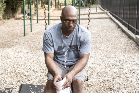 Man on a swing suicidal man in a playground