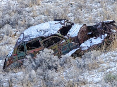 Rusty car snow covered photo