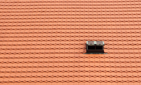 Red Tile Roof with Small Window photo
