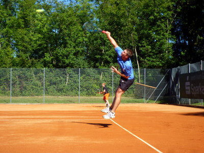 Man Hitting a Jump Shot in Tennis photo
