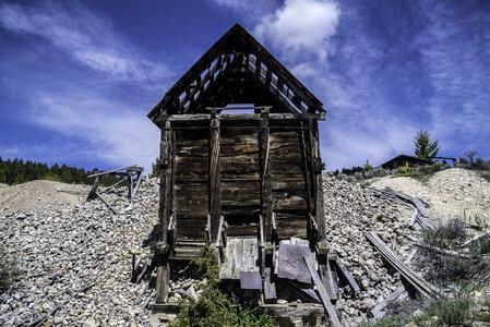 Old Rustic Cabin under blue sky and clouds in Elkhorn, Montana photo