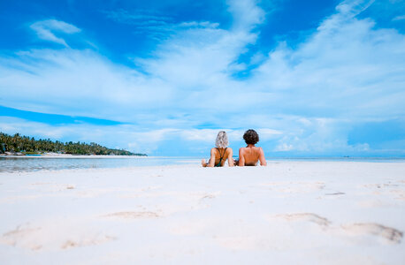 Beautiful Tropical Landscape Young Couple Lying on a Beach photo